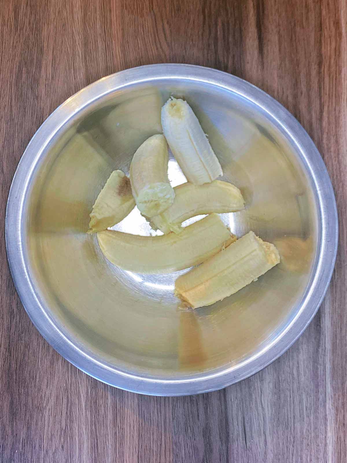 Broken bananas in a mixing bowl.