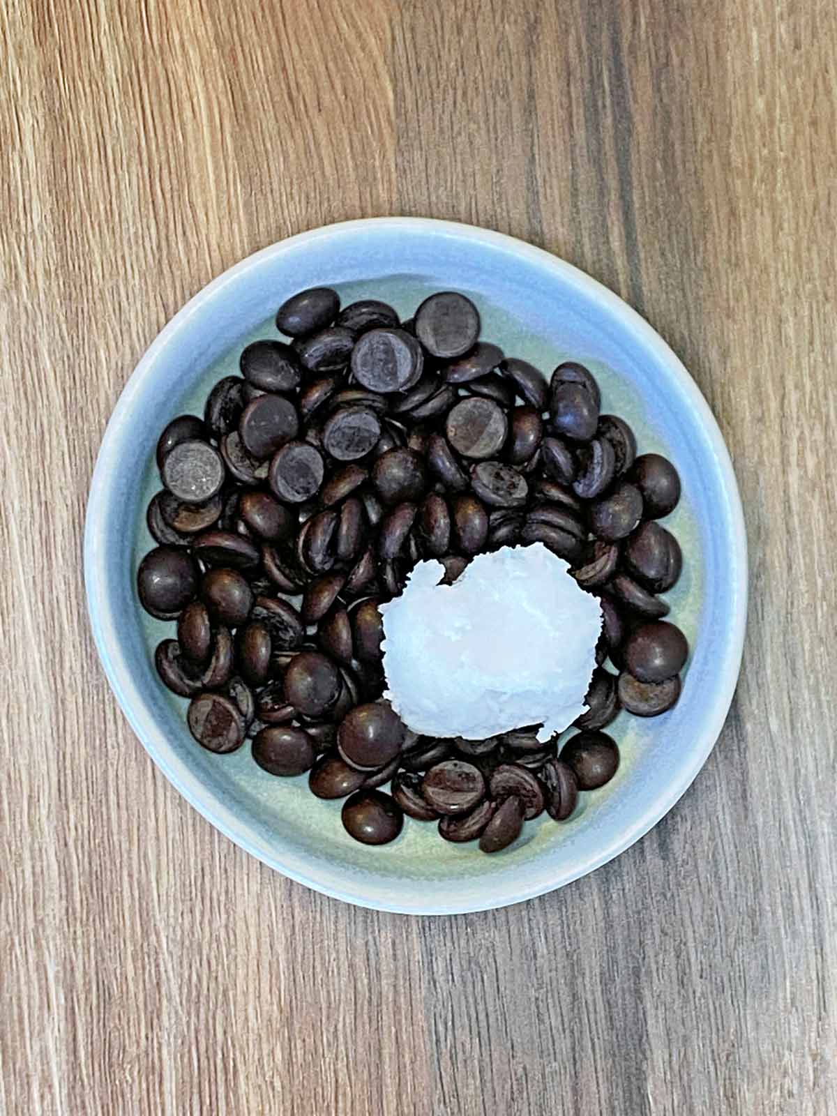 A bowl of chocolate chips and coconut oil.