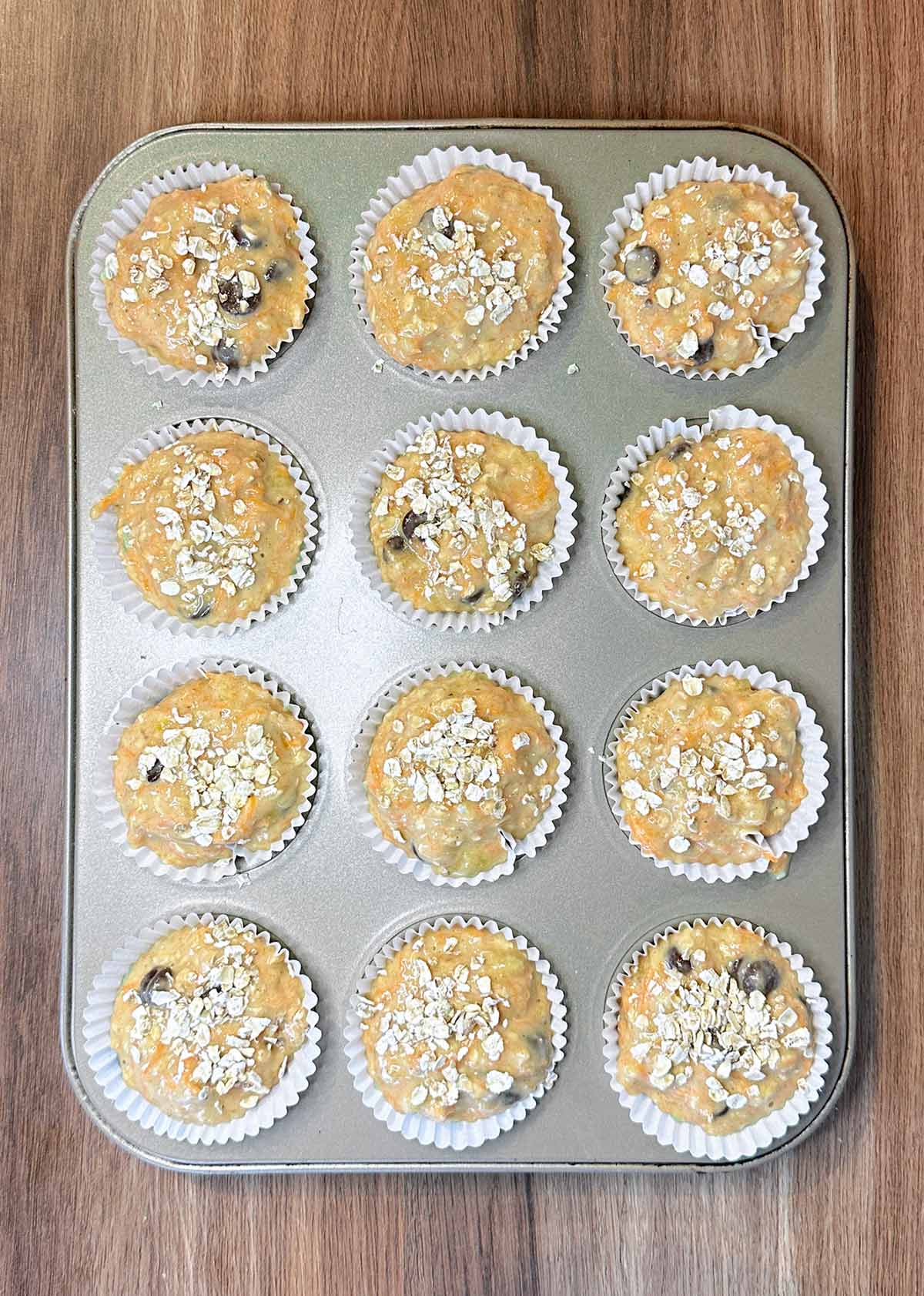 The batter divided between twelve muffin cases.