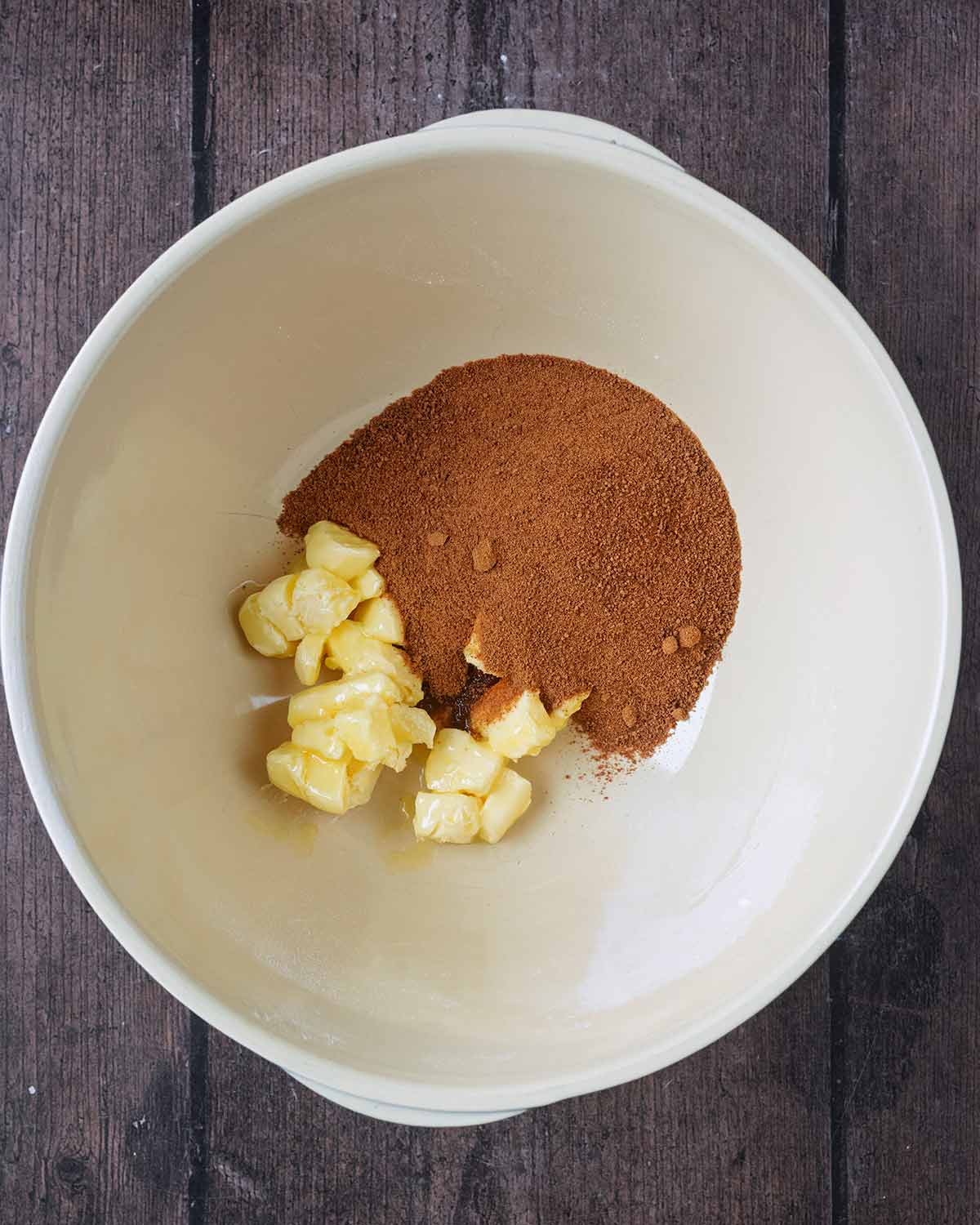 A large mixing bowl with butter and coconut sugar in it.